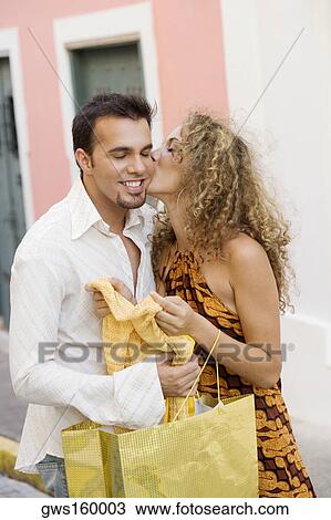 Stock Image - Teenage girl kissing a mid adult man. Fotosearch