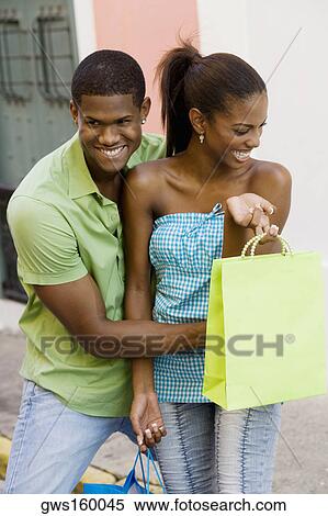 Stock Photography - Young man embracing a teenage girl. Fotosearch