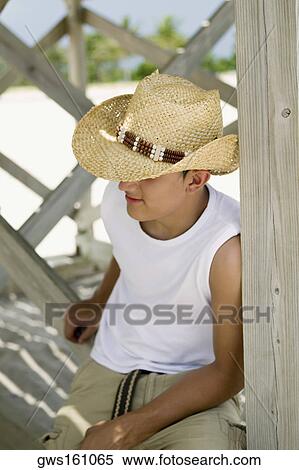 Close-up of a teenage boy wearing a straw hat View Large Photo Image Stock Photography - Close-up of a teenage boy wearing a straw hat. Fotosearch