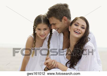 Close-up of a young couple and their daughter on the beach View Large Photo Image Stock Image - Close-up of a young couple and their daughter on the beach. Fotosearch