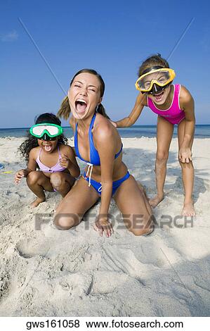 Close-up of a young woman and two girls on the beach View Large Photo Image Stock Photo - Close-up of a young woman and two girls on the beach. Fotosearch