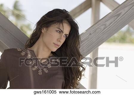 Close-up of a young woman looking away View Large Photo Image Stock Photography - Close-up of a young woman looking away. Fotosearch