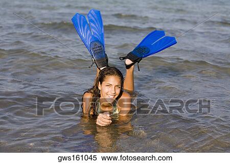 Portrait of a teenage girl lying in water and wearing flippers View Large Photo Image Stock Photography - Portrait of a teenage girl lying in water and wearing flippers. Fotosearch