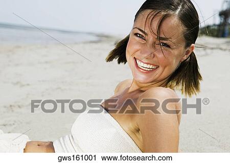 Stock Image - Portrait of a young woman smiling. Fotosearch