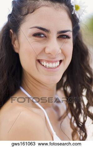 Stock Image - Portrait of a young woman smiling. Fotosearch