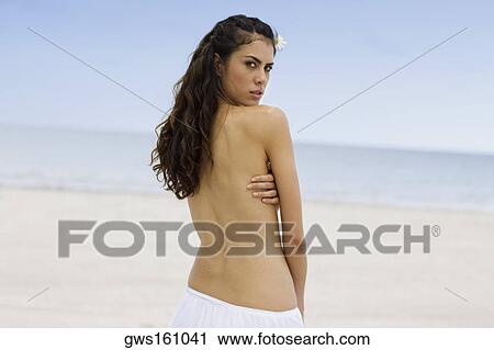 Portrait of a young woman standing on the beach View Large Photo Image Stock Image - Portrait of a young woman standing on the beach. Fotosearch