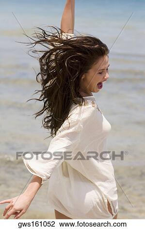 Side profile of a young woman on the beach View Large Photo Image Stock Image - Side profile of a young woman on the beach. Fotosearch