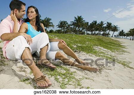 Close-up of a young couple smiling on the beach View Large Photo Image Stock Photo - Close-up of a young couple smiling on the beach. Fotosearch