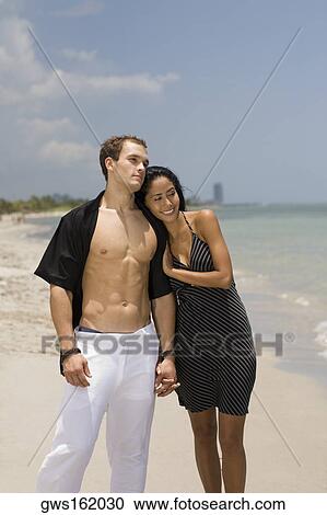 Close-up of a young couple standing on the beach View Large Photo Image Stock Image - Close-up of a young couple standing on the beach. Fotosearch