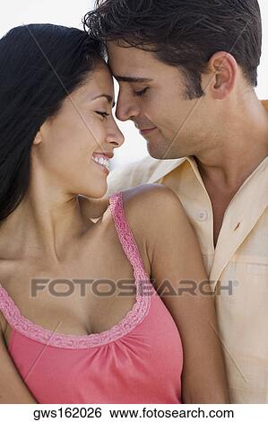 Close-up of a young man embracing a young woman View Large Photo Image Stock Photograph - Close-up of a young man embracing a young woman. Fotosearch