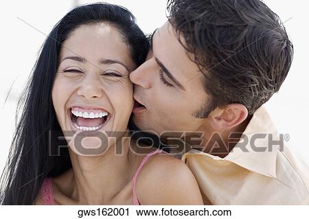 Close-up of a young man kissing a young woman View Large Photo Image Stock Image - Close-up of a young man kissing a young woman. Fotosearch