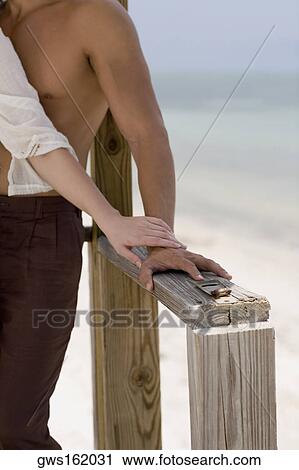 Close-up of a young man standing on the pier with a young woman View Large Photo Image Stock Image - Close-up of a young man standing on the pier with a young woman. Fotosearch