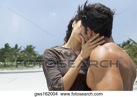 Close-up of a young woman and a mid adult man kissing each other View Large Photo Image Picture - Close-up of a young woman and a mid adult man kissing each other. Fotosearch
