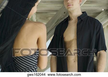 Close-up of a young woman standing with a young man View Large Photo Image Picture - Close-up of a young woman standing with a young man. Fotosearch