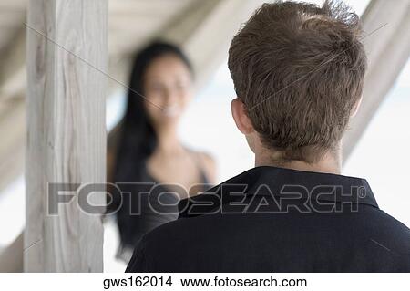 Rear view of a young man with a young woman View Large Photo Image Picture - Rear view of a young man with a young woman. Fotosearch