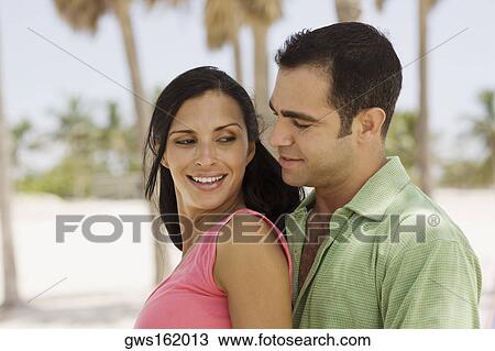 Side profile of a young couple smiling View Large Photo Image Stock Image - Side profile of a young couple smiling. Fotosearch