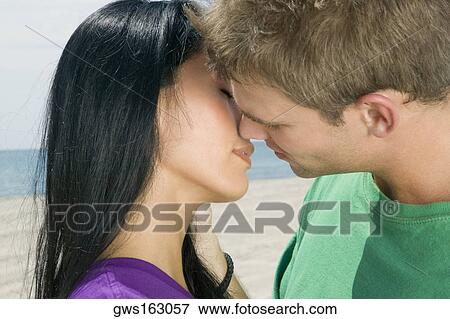 Close-up of a young couple kissing View Large Photo Image Stock Photo - Close-up of a young couple kissing. Fotosearch