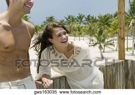 Close-up of a young couple smiling View Large Photo Image Stock Photography - Close-up of a young couple smiling. Fotosearch