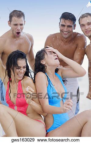 Group of people playing with water View Large Photo Image Stock Photo - Group of people playing with water. Fotosearch