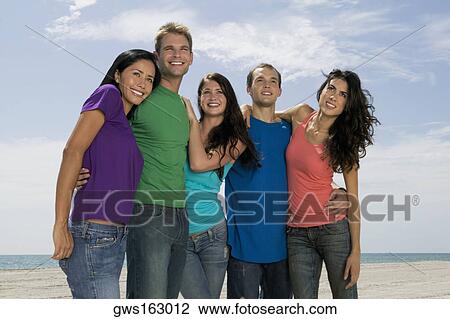 Low angle view of three young women and two young men jumping on the beach View Large Photo Image Stock Image - Low angle view of three young women and two young men jumping on the beach. Fotosearch