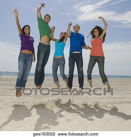 Portrait of five young people jumping on the beach View Large Photo Image Stock Image - Portrait of five young people jumping on the beach. Fotosearch