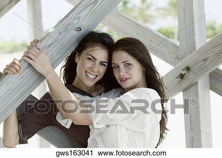 Portrait of two young women smiling View Large Photo Image Stock Image - Portrait of two young women smiling. Fotosearch