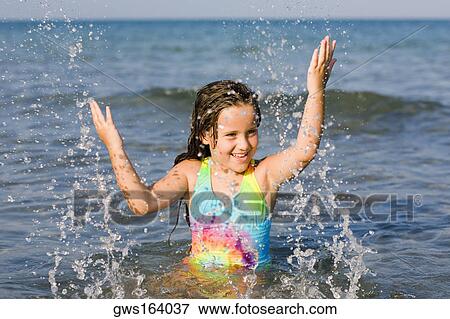 Stock Photo - Close-up of a girl playing in the sea. Fotosearch