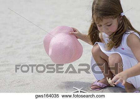 Close-up of a girl playing with a starfish on the beach View Large Photo Image Stock Photography - Close-up of a girl playing with a starfish on the beach. Fotosearch