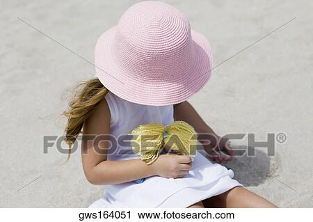 High angle view of a girl playing with a doll on the beach View Large Photo Image Stock Image - High angle view of a girl playing with a doll on the beach. Fotosearch