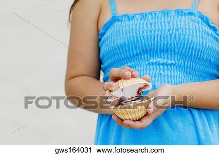 Mid section view of a girl holding a seashell View Large Photo Image Stock Image - Mid section view of a girl holding a seashell. Fotosearch