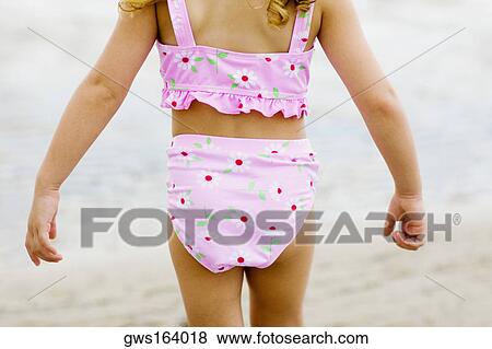 Mid section view of a girl walking on the beach View Large Photo Image Stock Photo - Mid section view of a girl walking on the beach. Fotosearch
