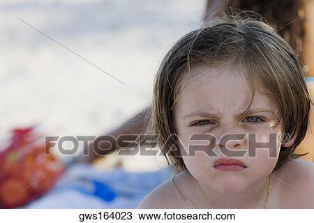 Stock Image - Portrait of a boy making a face. Fotosearch