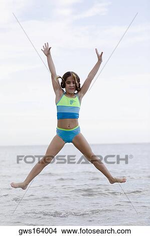 Portrait of a girl jumping on the beach View Large Photo Image Picture - Portrait of a girl jumping on the beach. Fotosearch