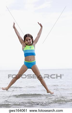 Portrait of a girl jumping on the beach View Large Photo Image Stock Image - Portrait of a girl jumping on the beach. Fotosearch