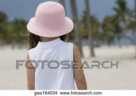 Rear view of a girl standing on the beach View Large Photo Image Picture - Rear view of a girl standing on the beach. Fotosearch
