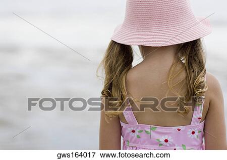 Rear view of a girl standing on the beach View Large Photo Image Stock Photo - Rear view of a girl standing on the beach. Fotosearch