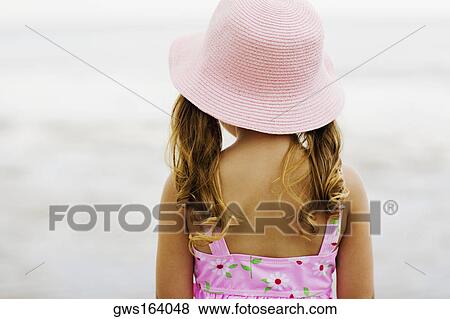 Rear view of a girl standing on the beach View Large Photo Image Stock Photo - Rear view of a girl standing on the beach. Fotosearch