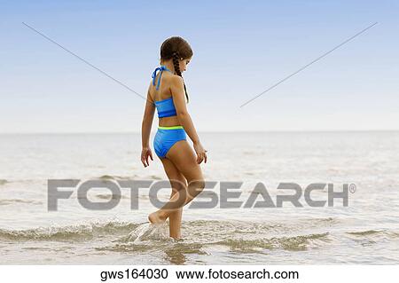 Side profile of a girl walking on the beach View Large Photo Image Stock Image - Side profile of a girl walking on the beach. Fotosearch