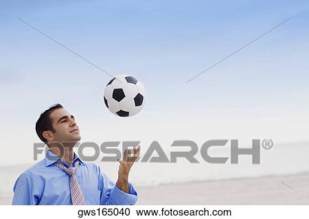 Close-up of a young man playing with a soccer ball View Large Photo Image Stock Image - Close-up of a young man playing with a soccer ball. Fotosearch
