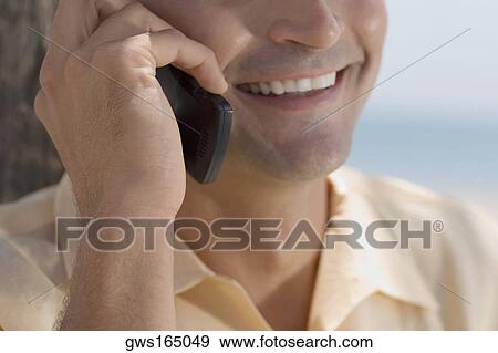 Close-up of a young man using a mobile phone View Large Photo Image Stock Photo - Close-up of a young man using a mobile phone. Fotosearch