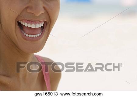 Stock Image - Close-up of a young woman laughing. Fotosearch