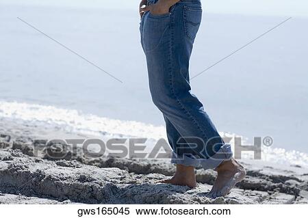 Low section view of a man walking on the beach View Large Photo Image Stock Photography - Low section view of a man walking on the beach. Fotosearch