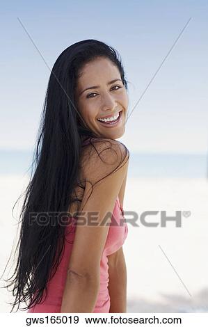 Portrait of a young woman smiling View Large Photo Image Stock Photo - Portrait of a young woman smiling. Fotosearch