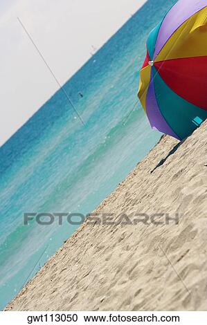 Beach umbrella on the beach View Large Photo Image Stock Image - Beach umbrella on the beach. Fotosearch