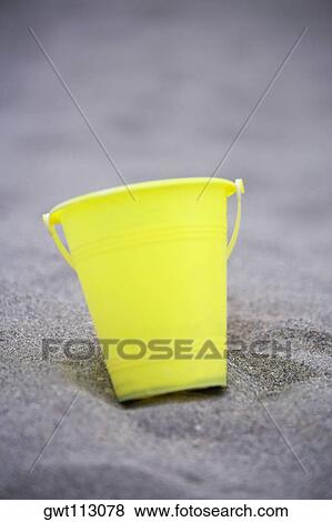 Close-up of a bucket on the sand View Large Photo Image Stock Photo - Close-up of a bucket on the sand. Fotosearch