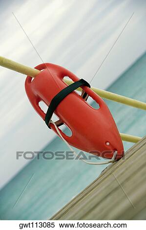 Close-up of a life jacket hanging on a pole View Large Photo Image Stock Photography - Close-up of a life jacket hanging on a pole. Fotosearch