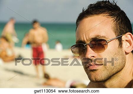 Close-up of a mid adult man thinking View Large Photo Image Picture - Close-up of a mid adult man thinking. Fotosearch