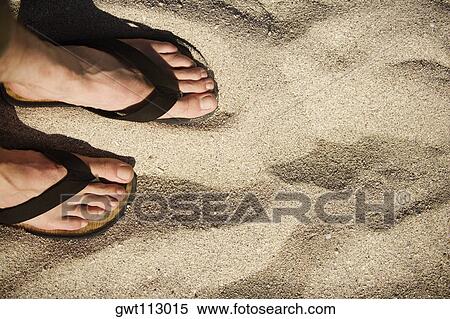 Stock Photography - Close-up of human feet wearing sandals. Fotosearch