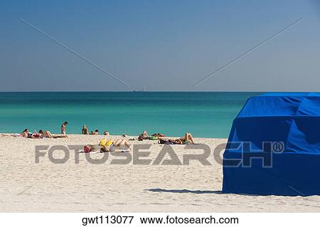 Stock Photo - Group of people on the beach. Fotosearch
