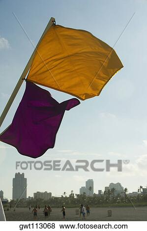 Low angle view of a flag fluttering View Large Photo Image Stock Photo - Low angle view of a flag fluttering. Fotosearch